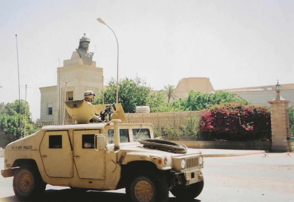 Photo of US tank driving by Saddam Hussein's palace.