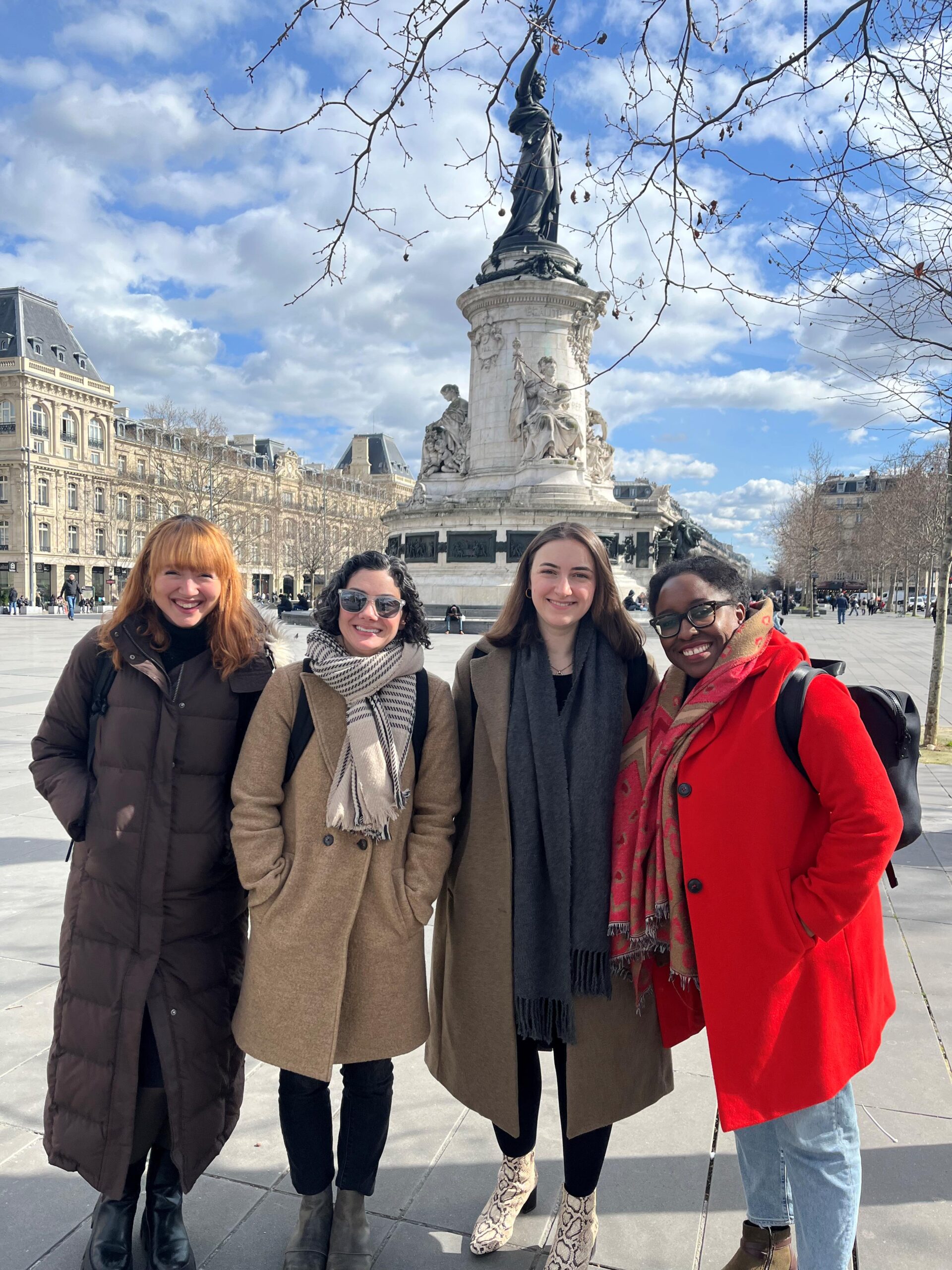 Susan Farbstein and Aminta Ossom standing outside with two students in Paris