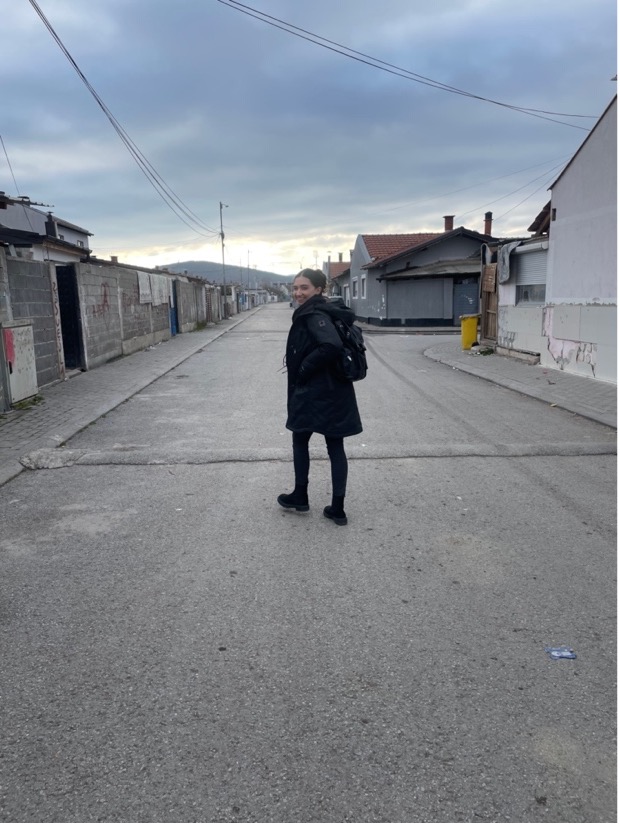 Giovanna walks down street in Kosovo